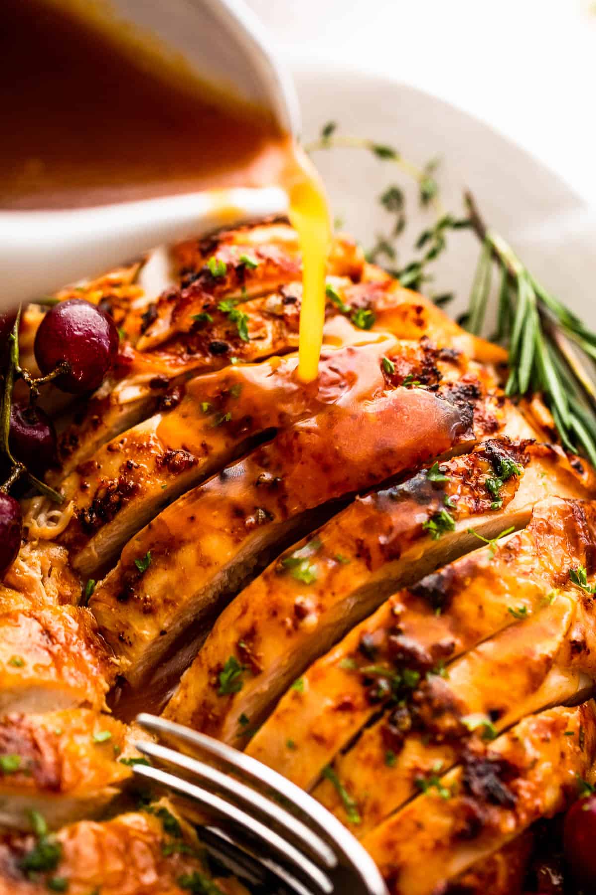 pouring gravy over sliced turkey breast