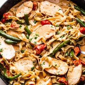 overhead shot of a skillet with Creole Blackened Chicken with Pasta, tomatoes, and green beans