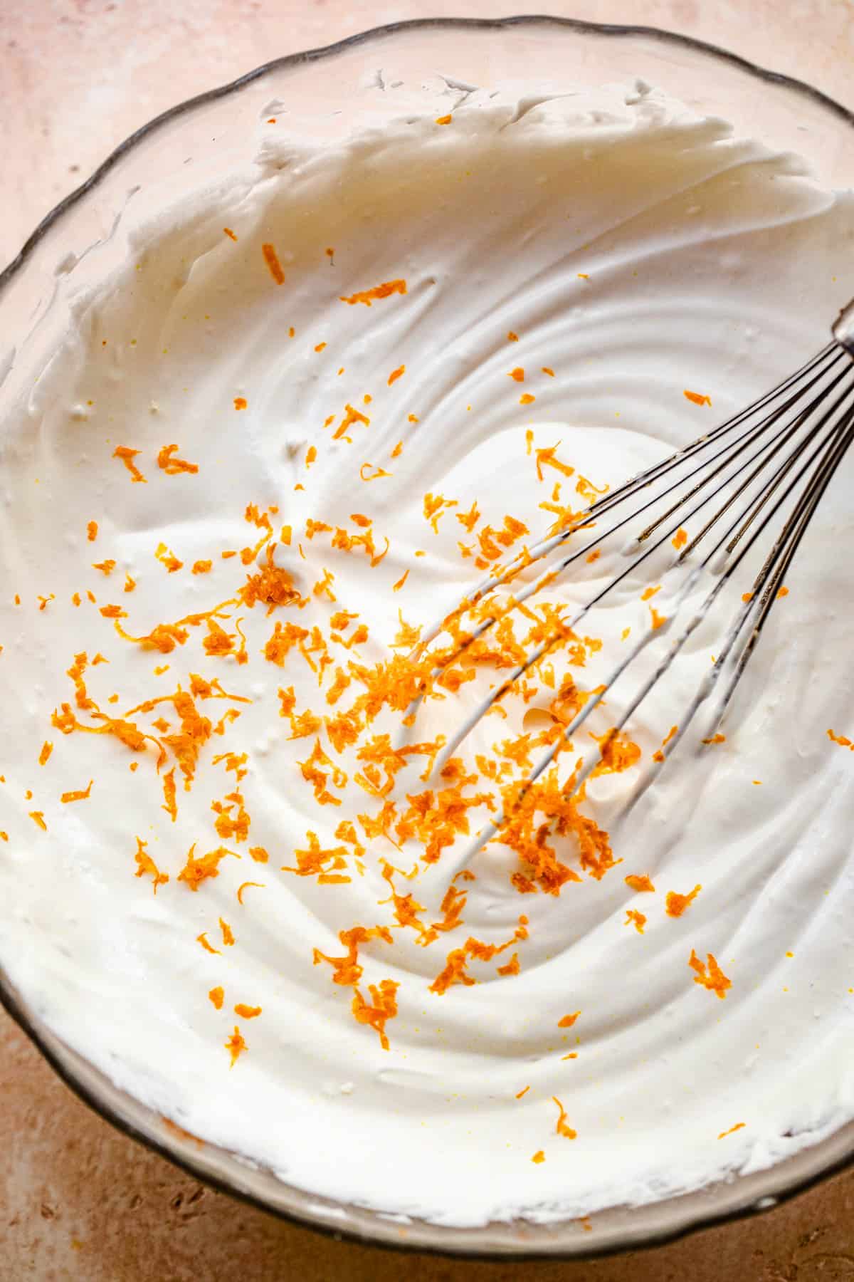 whisking cream of coconut in a large bowl to make a creamy coconut dip.