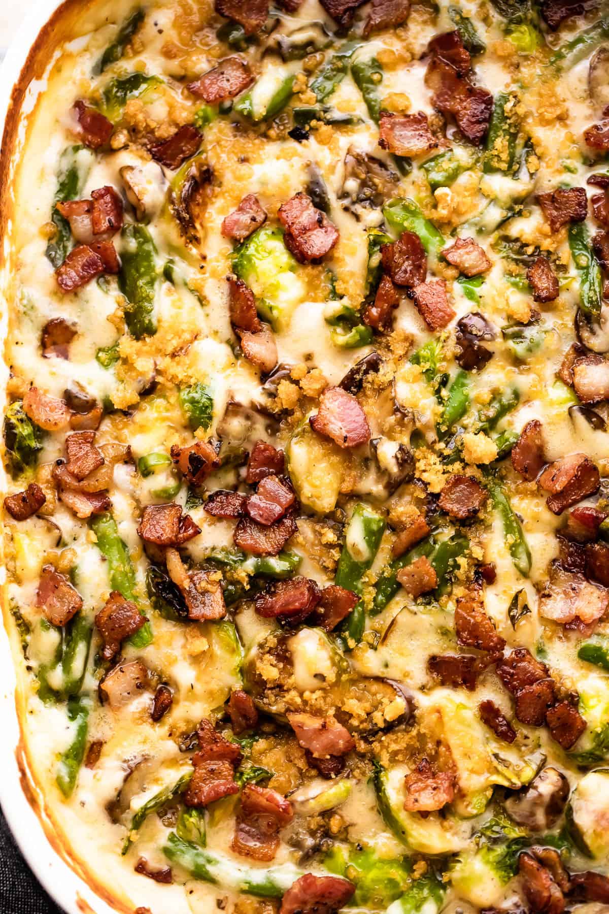 cooked green bean casserole topped with crispy diced bacon