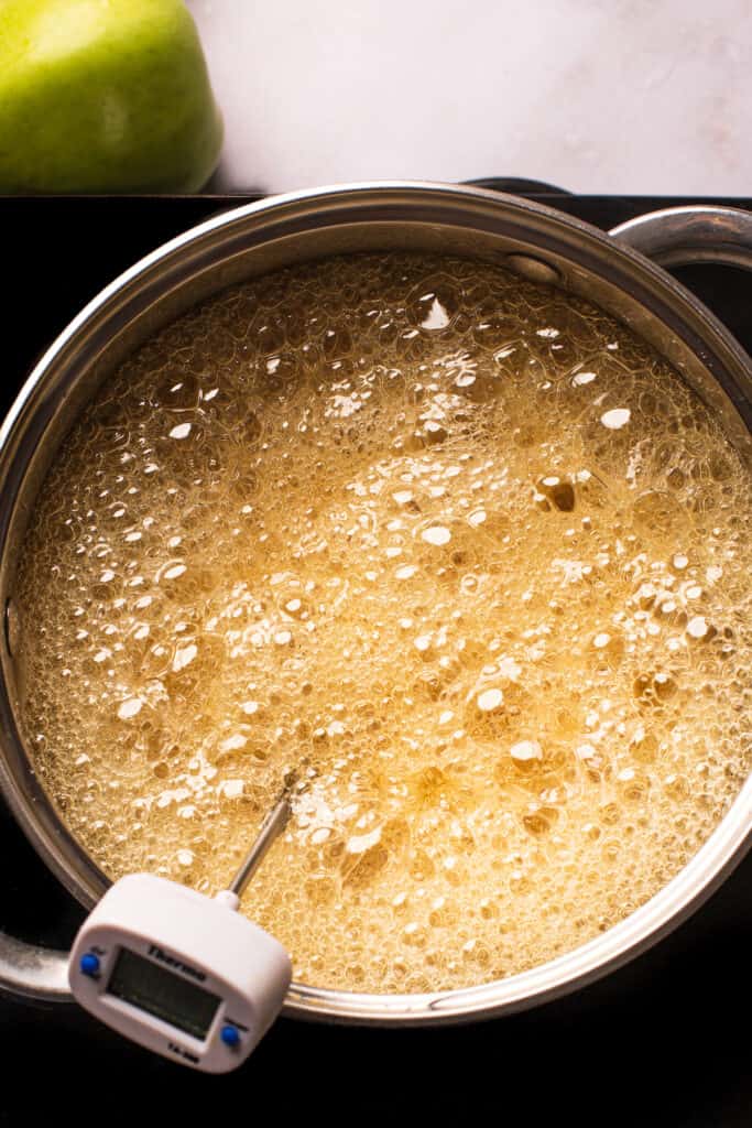A saucepan of boiling undyed sugar candy mixture.