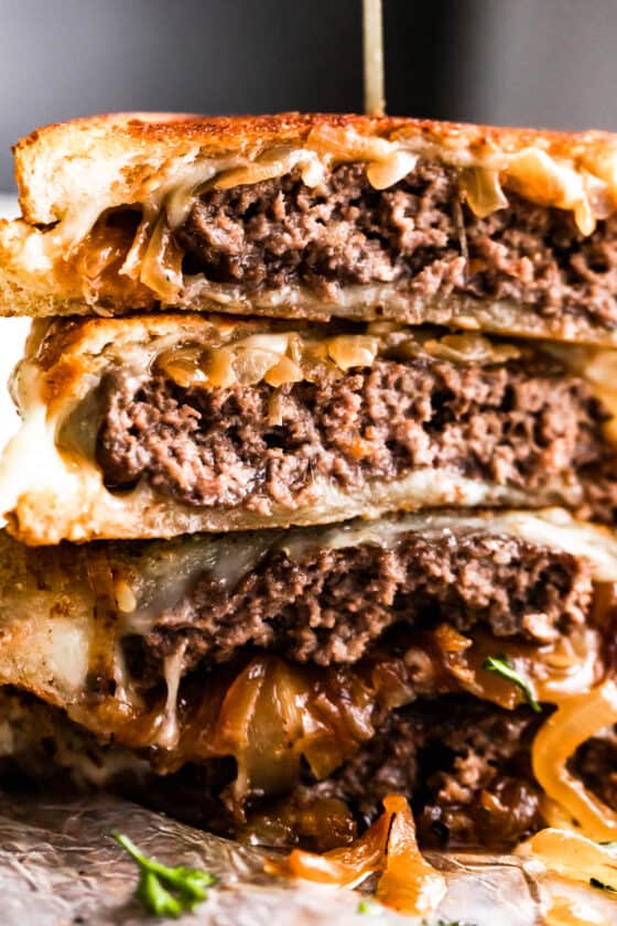 up close shot of cut into and stacked up patty melt sandwich.