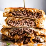 patty melt sandwich cut in halves and stacked up.