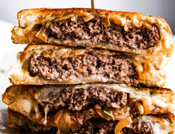 patty melt sandwich cut in halves and stacked up.