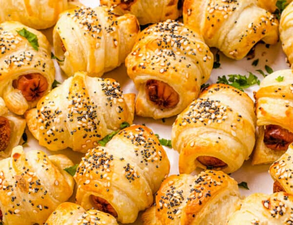 Close up shot of crescent roll hot dogs sprinkled with sesame and poppy seeds.