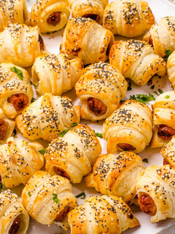 Close up shot of crescent roll hot dogs sprinkled with sesame and poppy seeds.