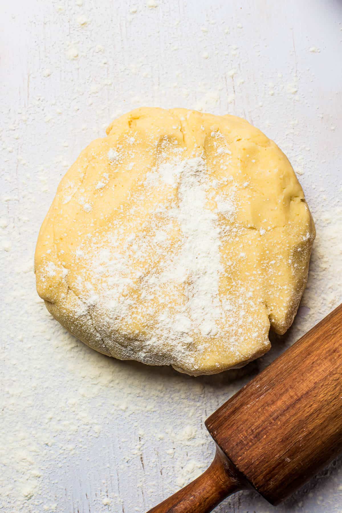 pie dough with a rolling pin next to it.