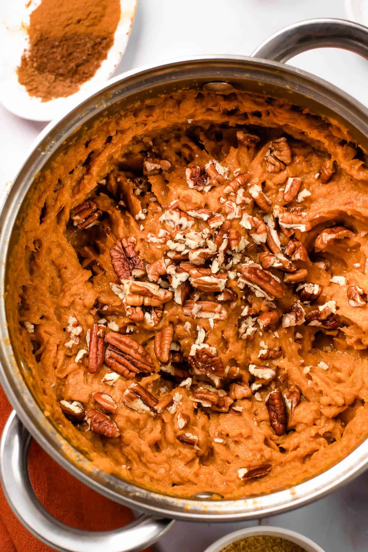 a. pot with mashed sweet potatoes topped with chopped pecans