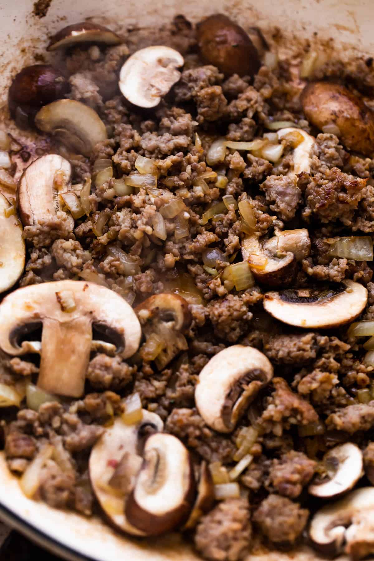 cooking ground beef with mushrooms to make beef stroganoff.
