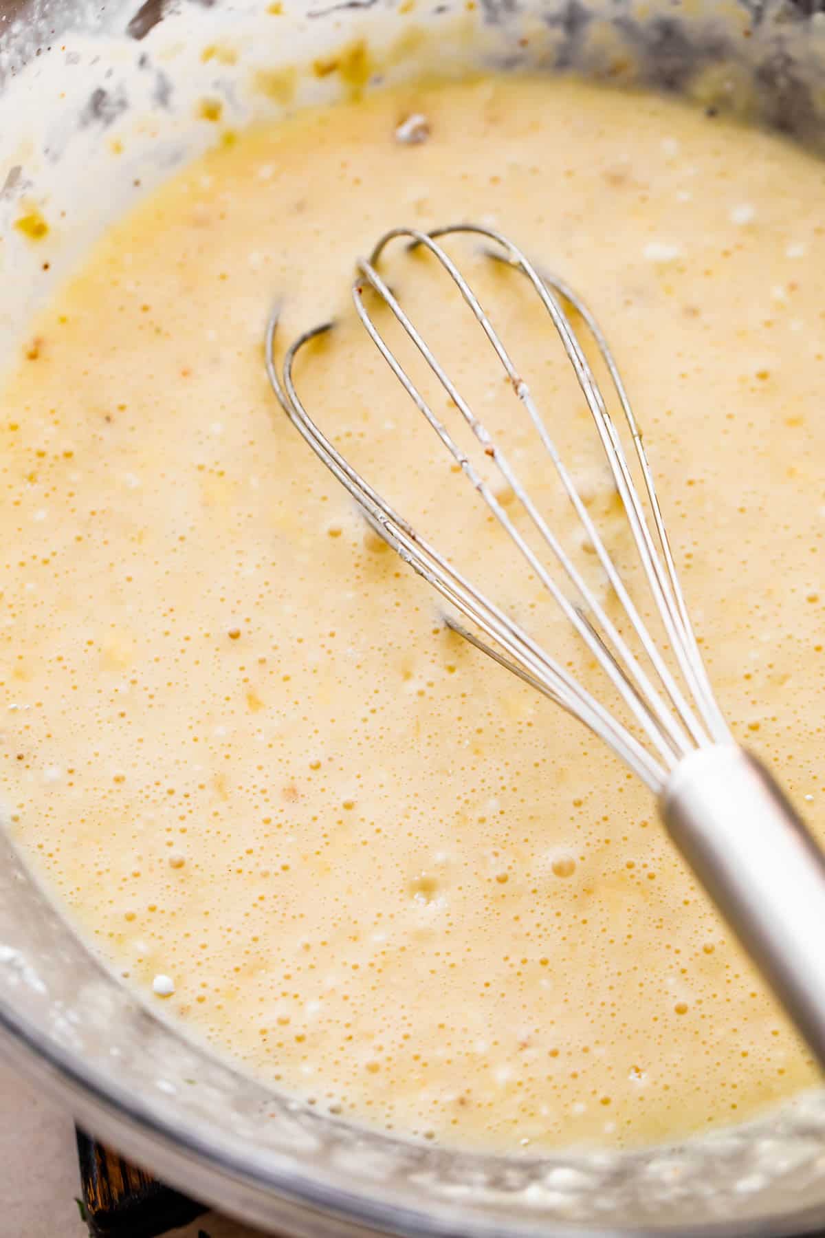 Melted butter, sugar, cornstarch, and cream in a glass mixing bowl.