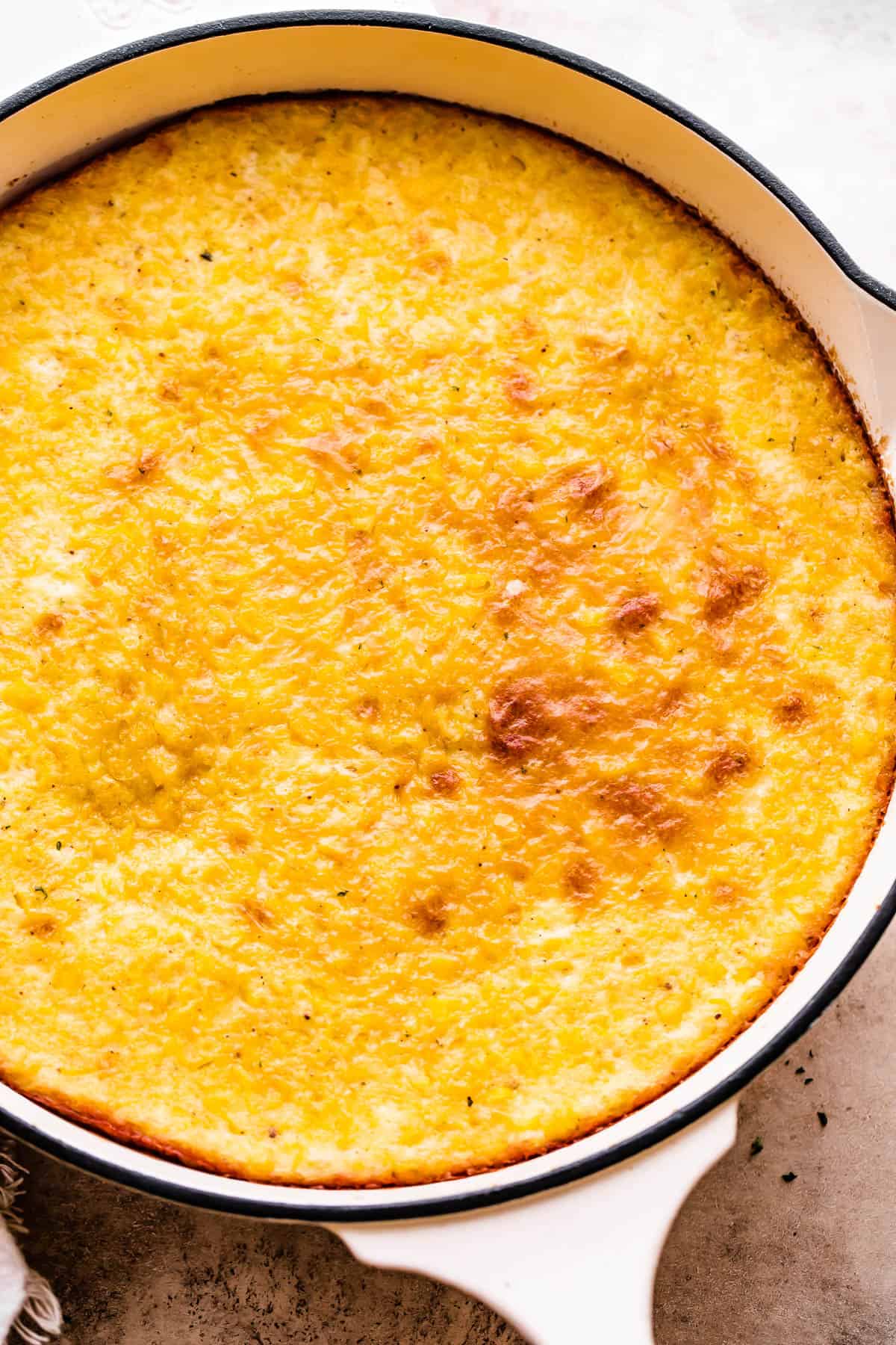 Baked corn pudding in a large skillet.