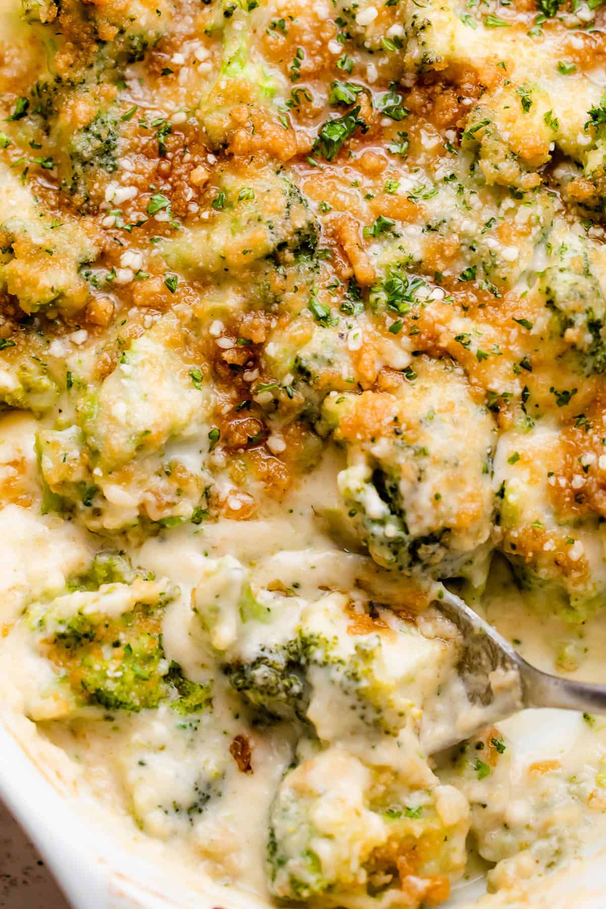 up close overhead shot of an oval baking dish with Cheesy Broccoli Casserole