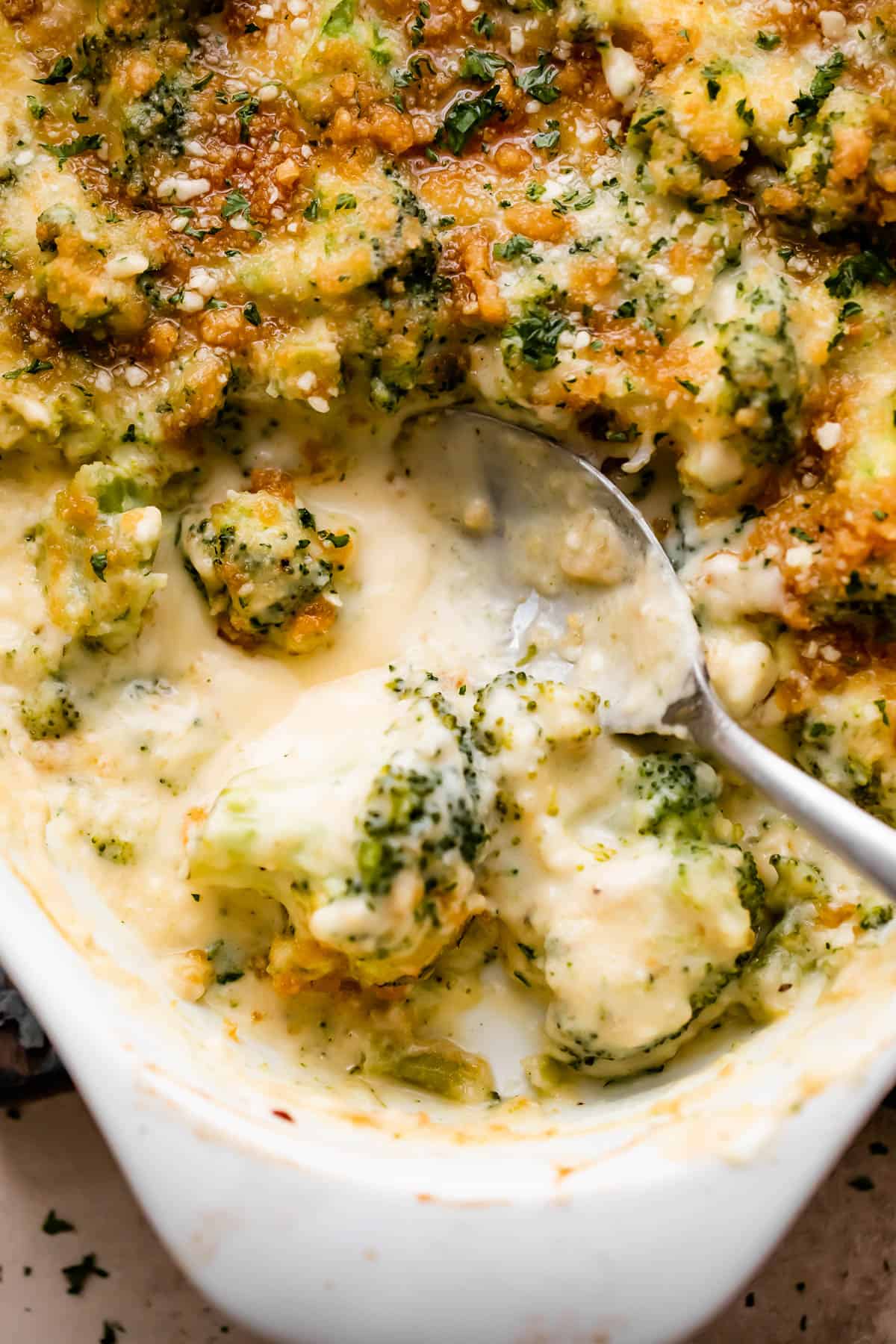 up close overhead shot of an oval baking dish with Cheesy Broccoli Casserole