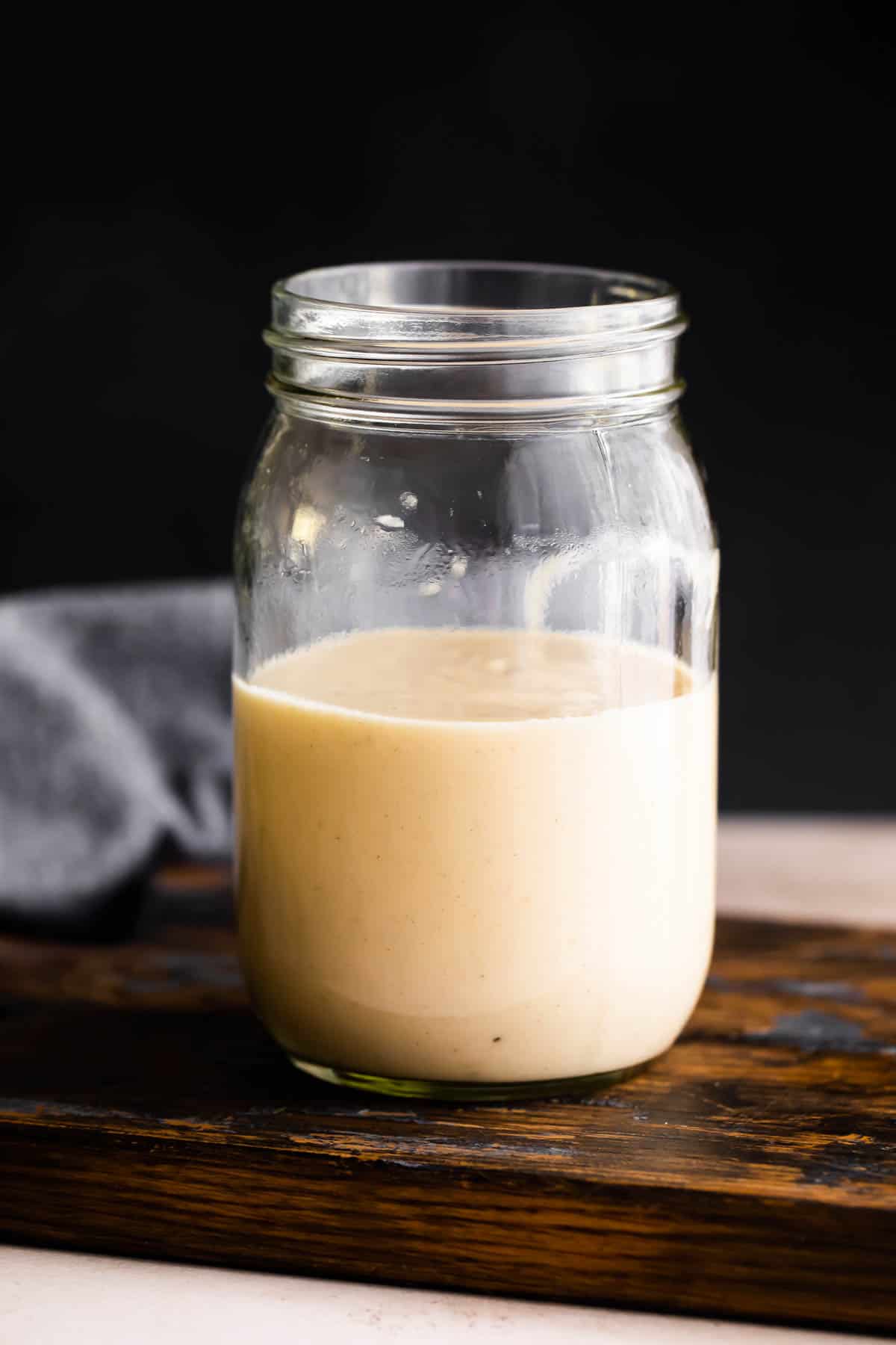 glass jar filled halfway up with homemade cream of chicken.