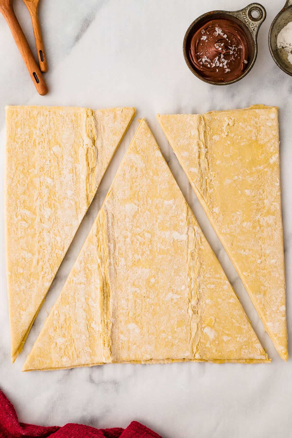 puff pastry sheet cut into 3 pieces to shape it into a christmas tree.