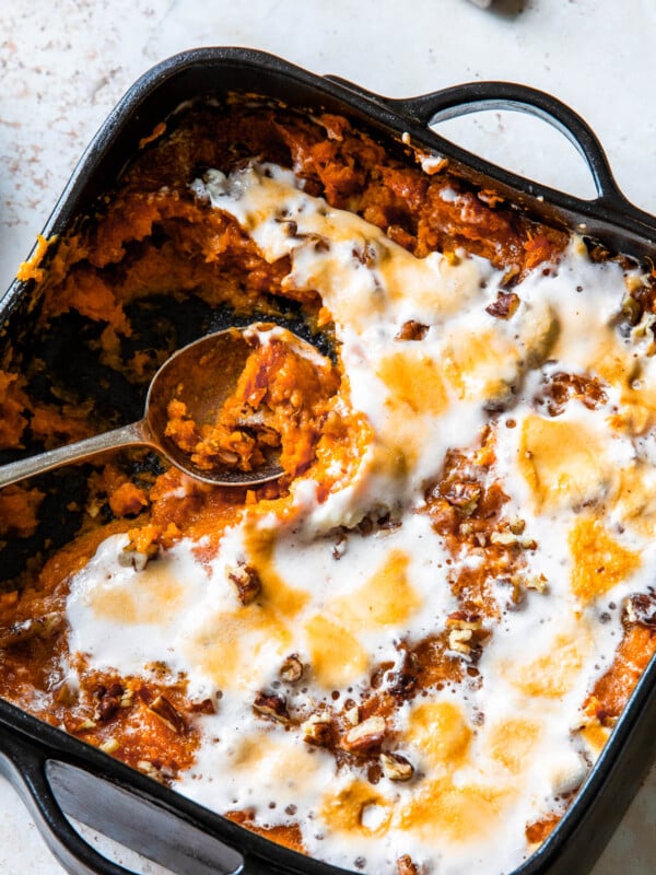 Sweet potato casserole with a spoon scooping out a portion.