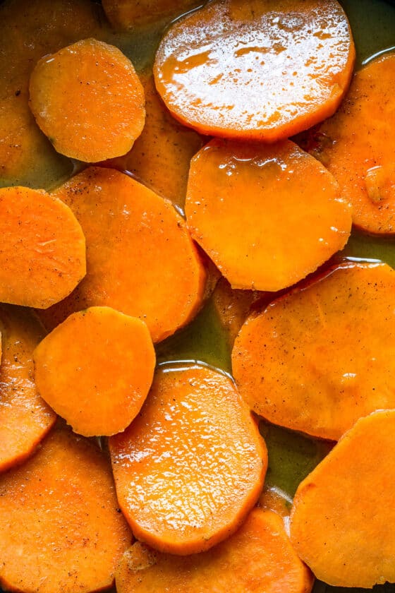 Sweet potatoes in syrup on a skillet.