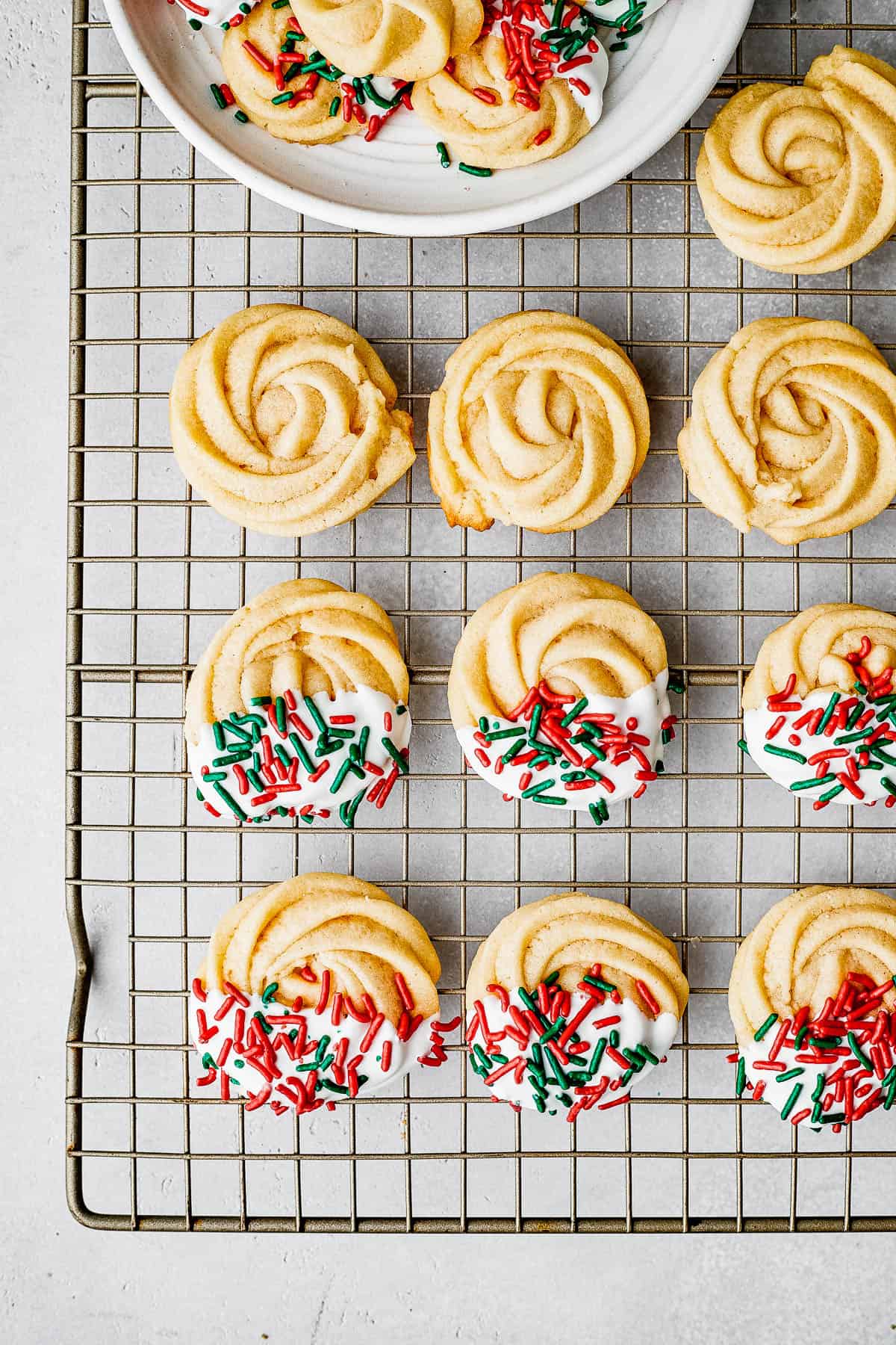 Decorated cookies drying on a cookie rack.