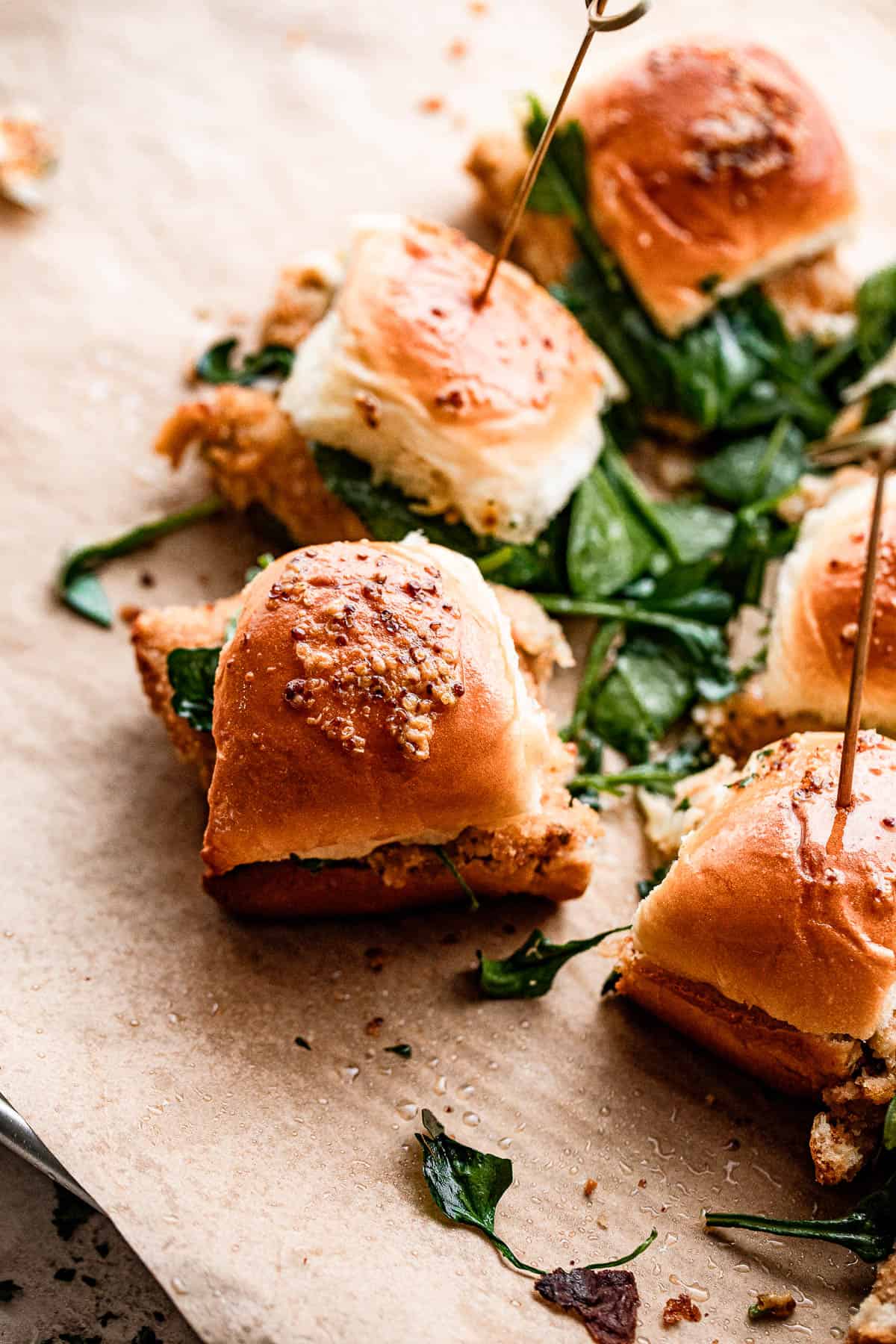 crab cake sliders arranged on brown paper.