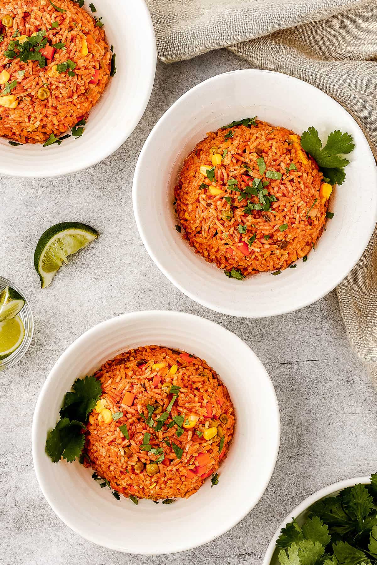 A serving of Mexican rice in a white bowl, garnished with cilantro.