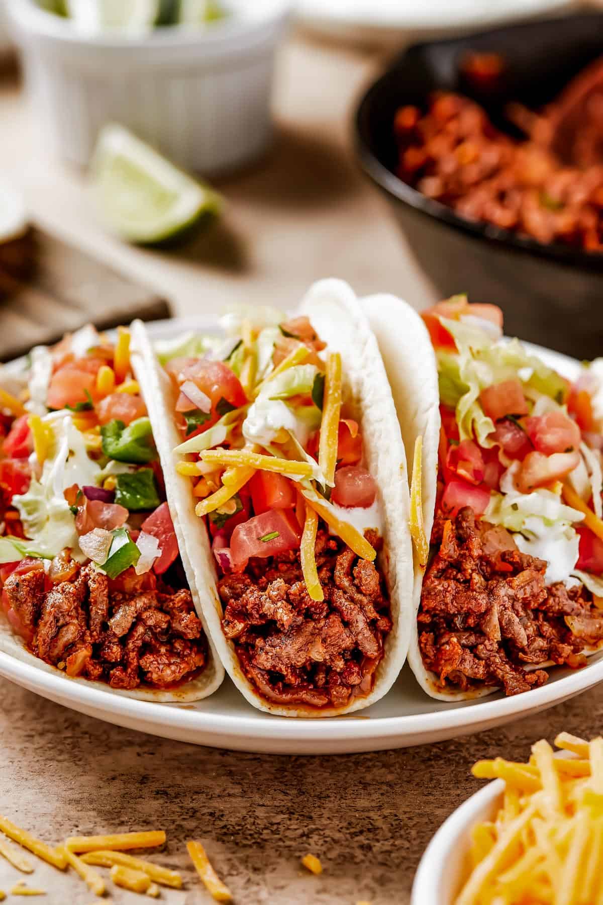 Tacos on a small white plate.