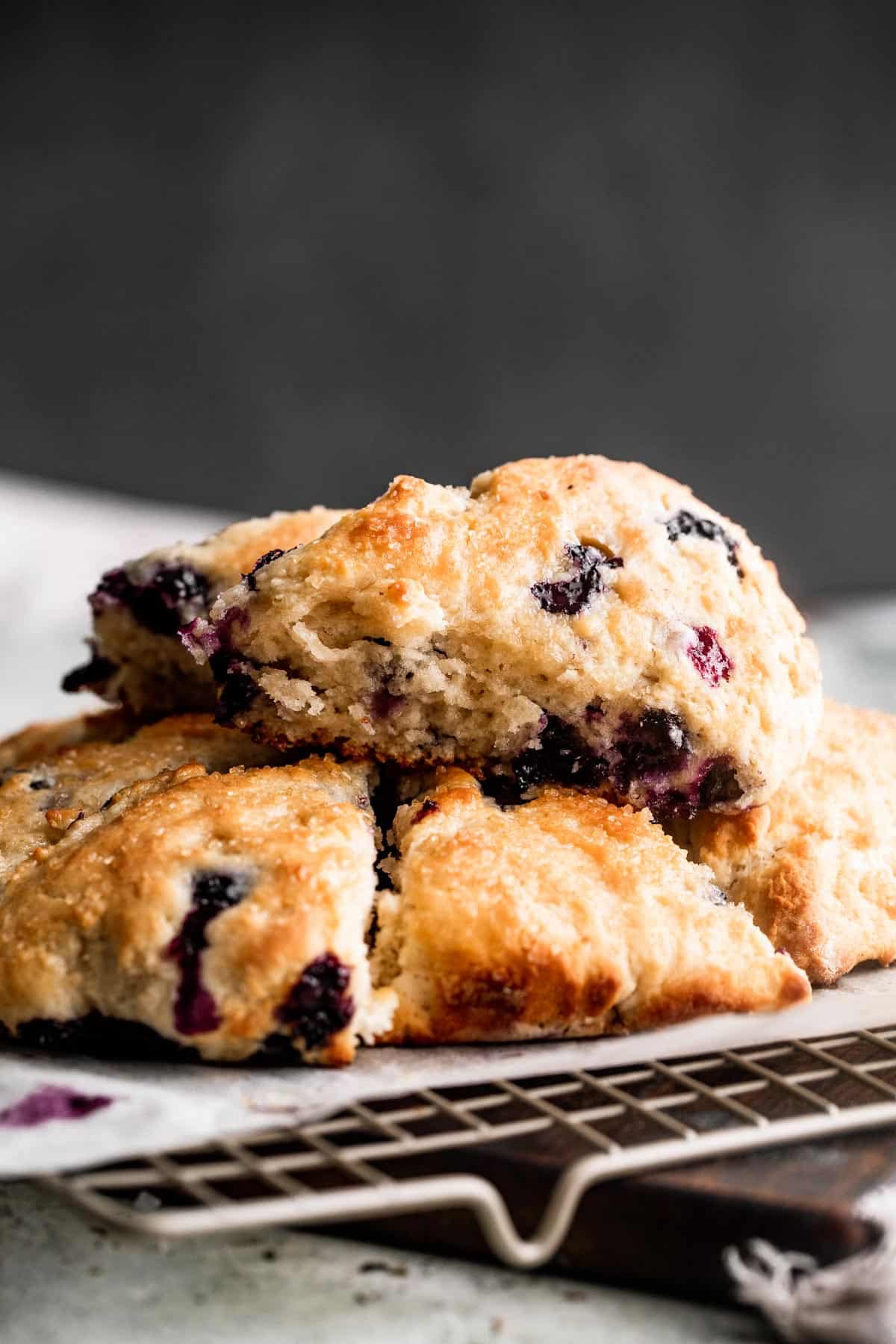 three blueberry scones set on a wire rack