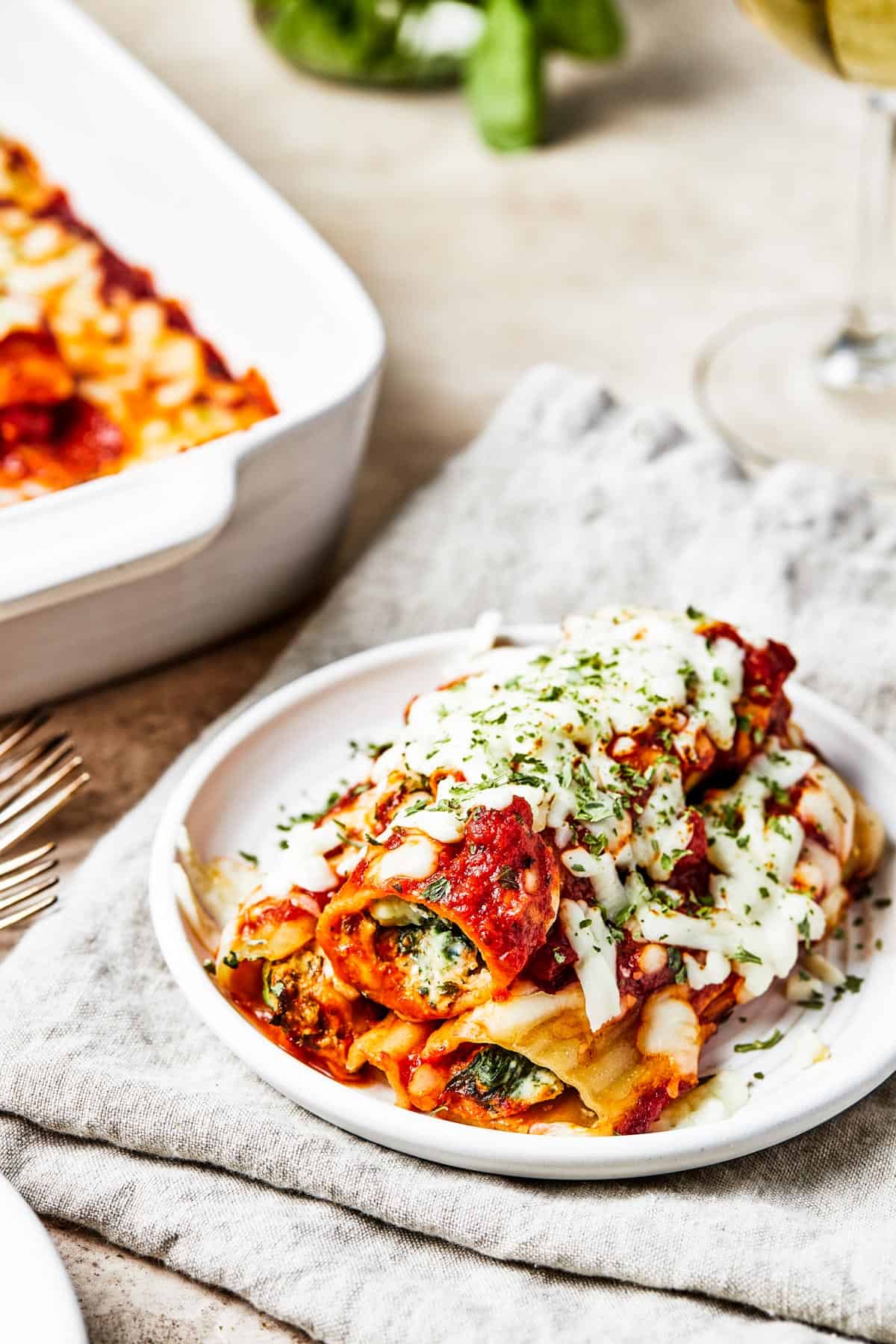 A serving of warm cheese pasta on a small white plate.