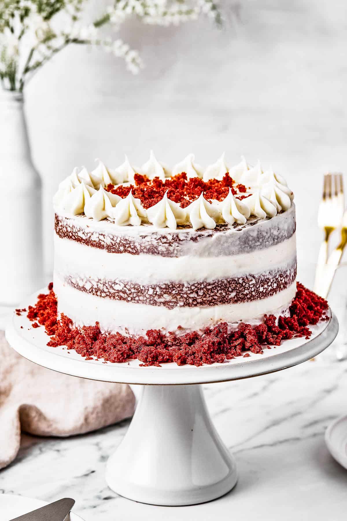A red velvet cake on a cake stand.