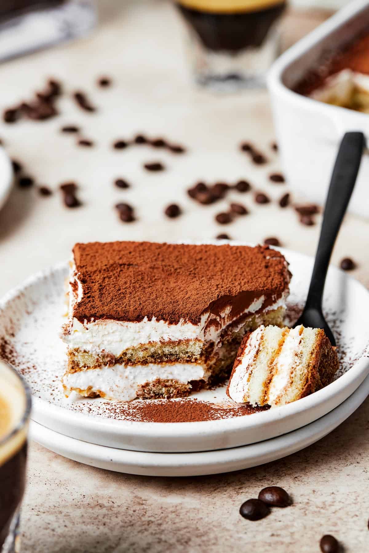 A serving of layered, chilled dessert with a forkful lying nearby on the plate.