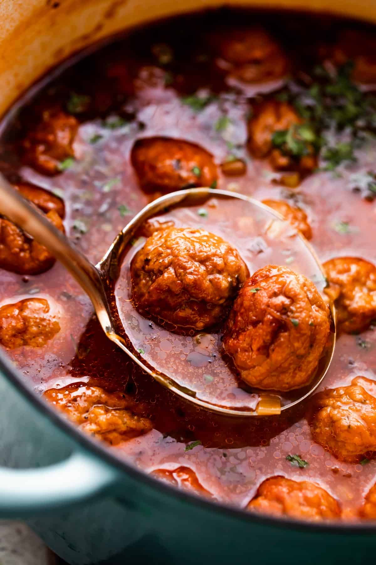 ladle spooning out Albondigas Soup from dutch oven.