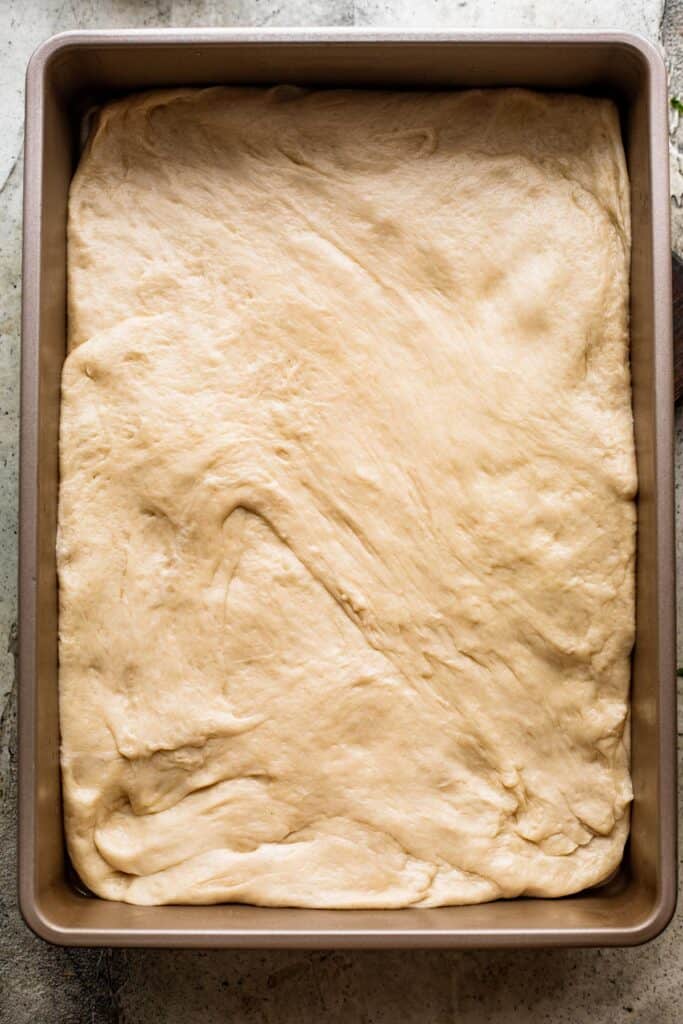 bread dough in a baking pan.
