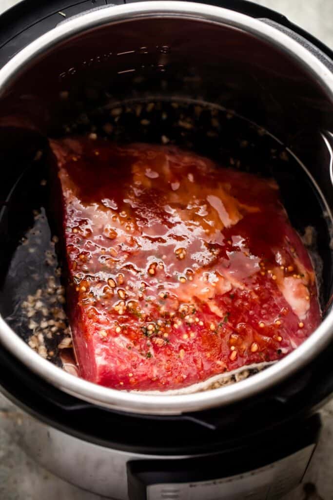raw corned beef placed in the instant pot.