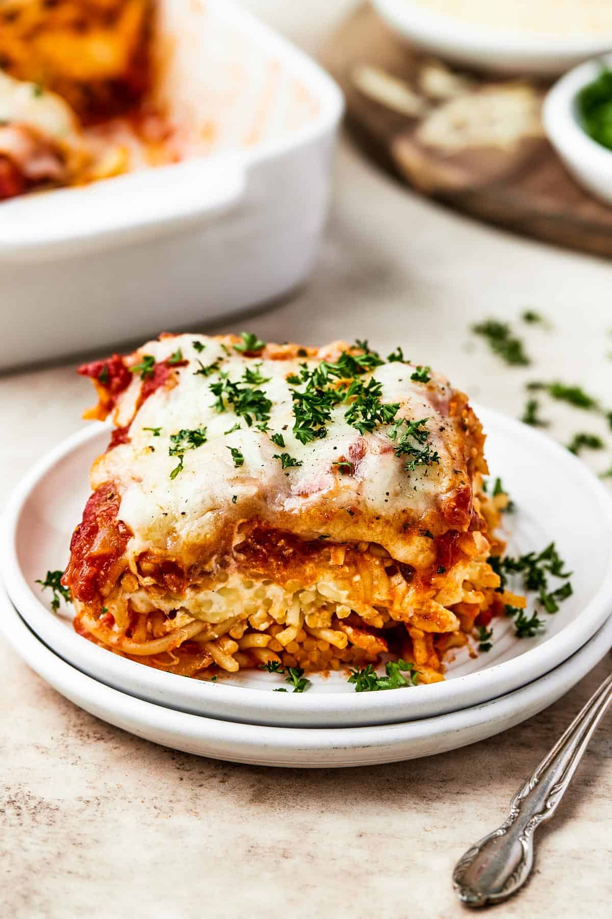 A square of baked spaghetti on a plate.