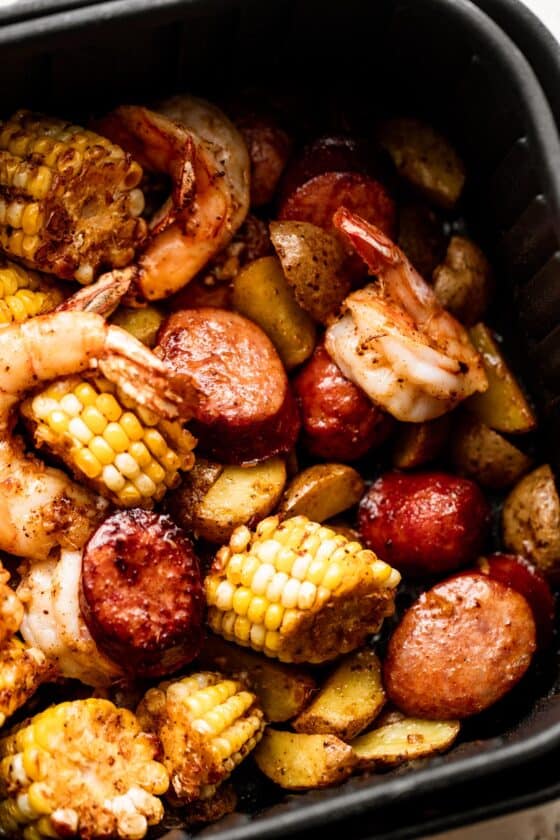 close up shot of corn on the cob rounds, andouille sausage rounds, and shrimp