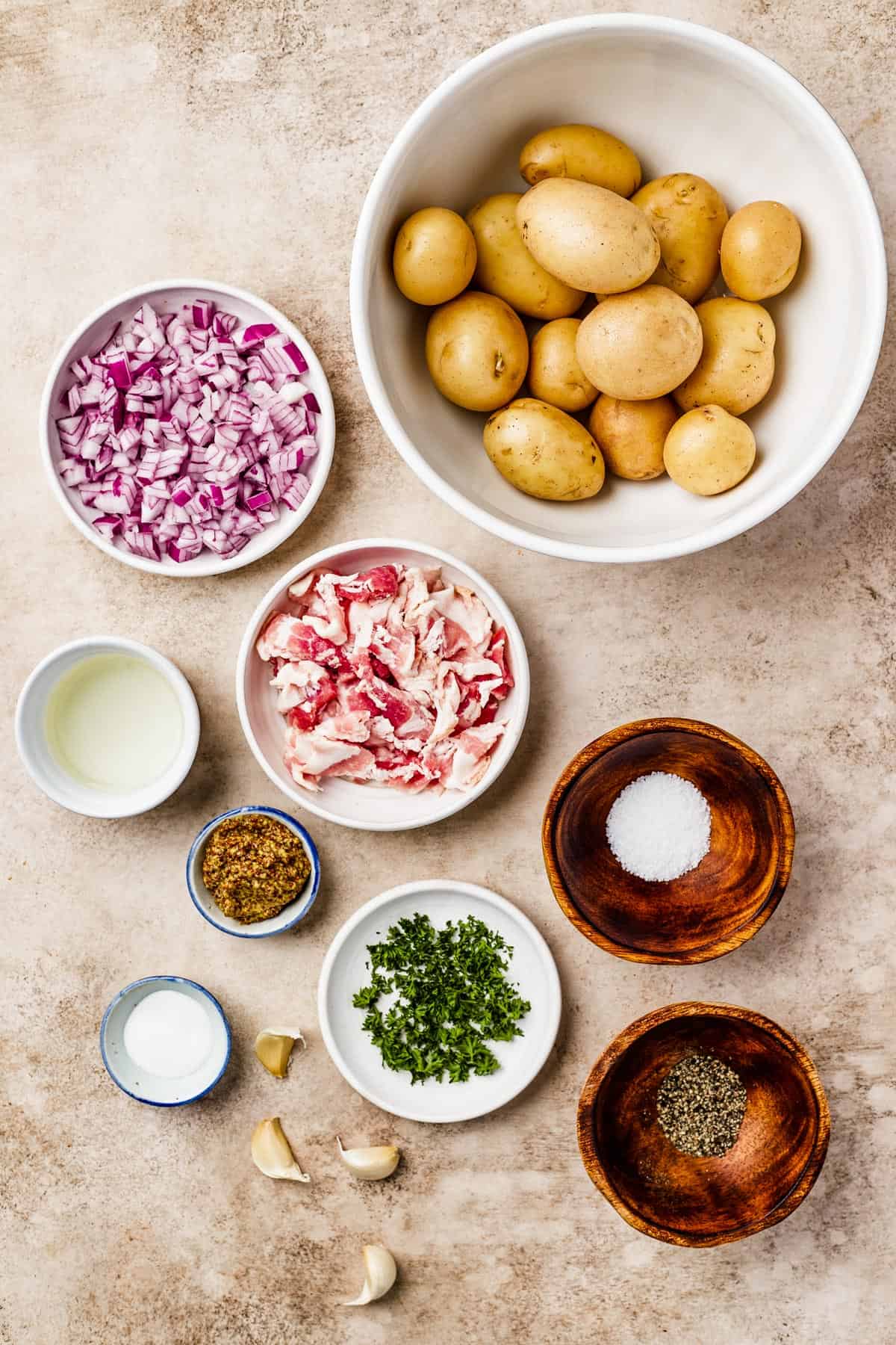 From top: Whole yellow potatoes, chopped red onion, white wine vinegar, chopped bacon, whole grain mustard, salt, sugar, garlic, parsley, pepper.