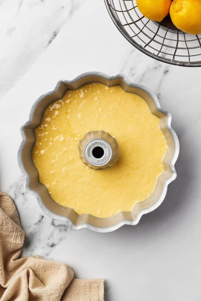 A Bundt pan filled with yellow batter.