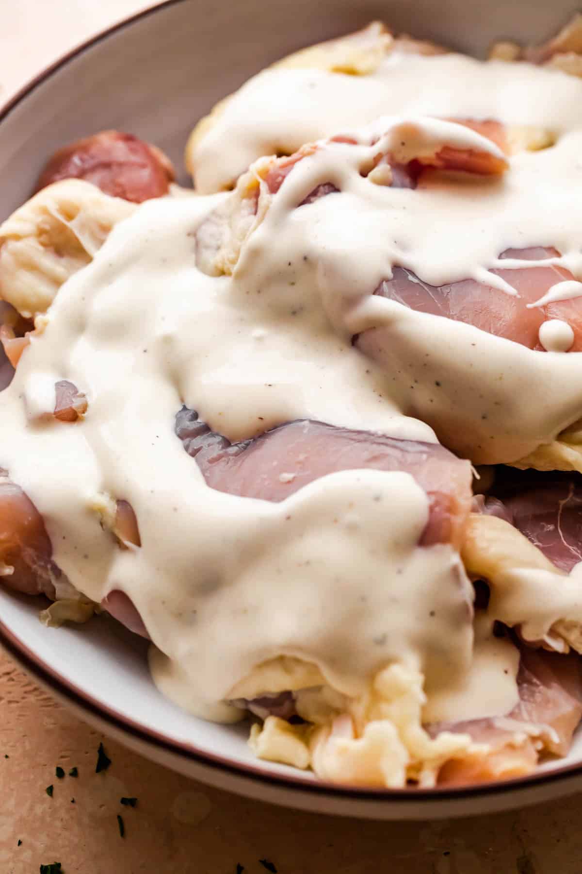 raw chicken thighs marinating in ranch dressing.