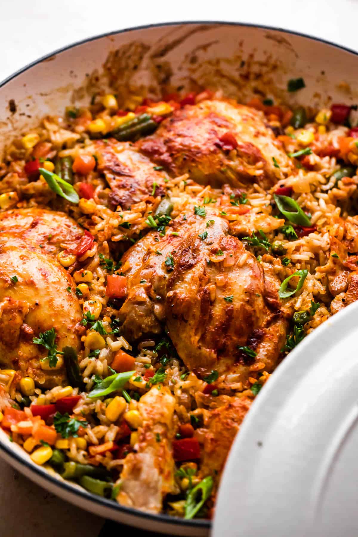 side view of cooked ranch chicken thighs with rice and vegetables.