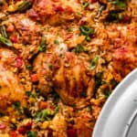 overhead shot of a round casserole dish with ranch chicken thighs, rice, and vegetables.