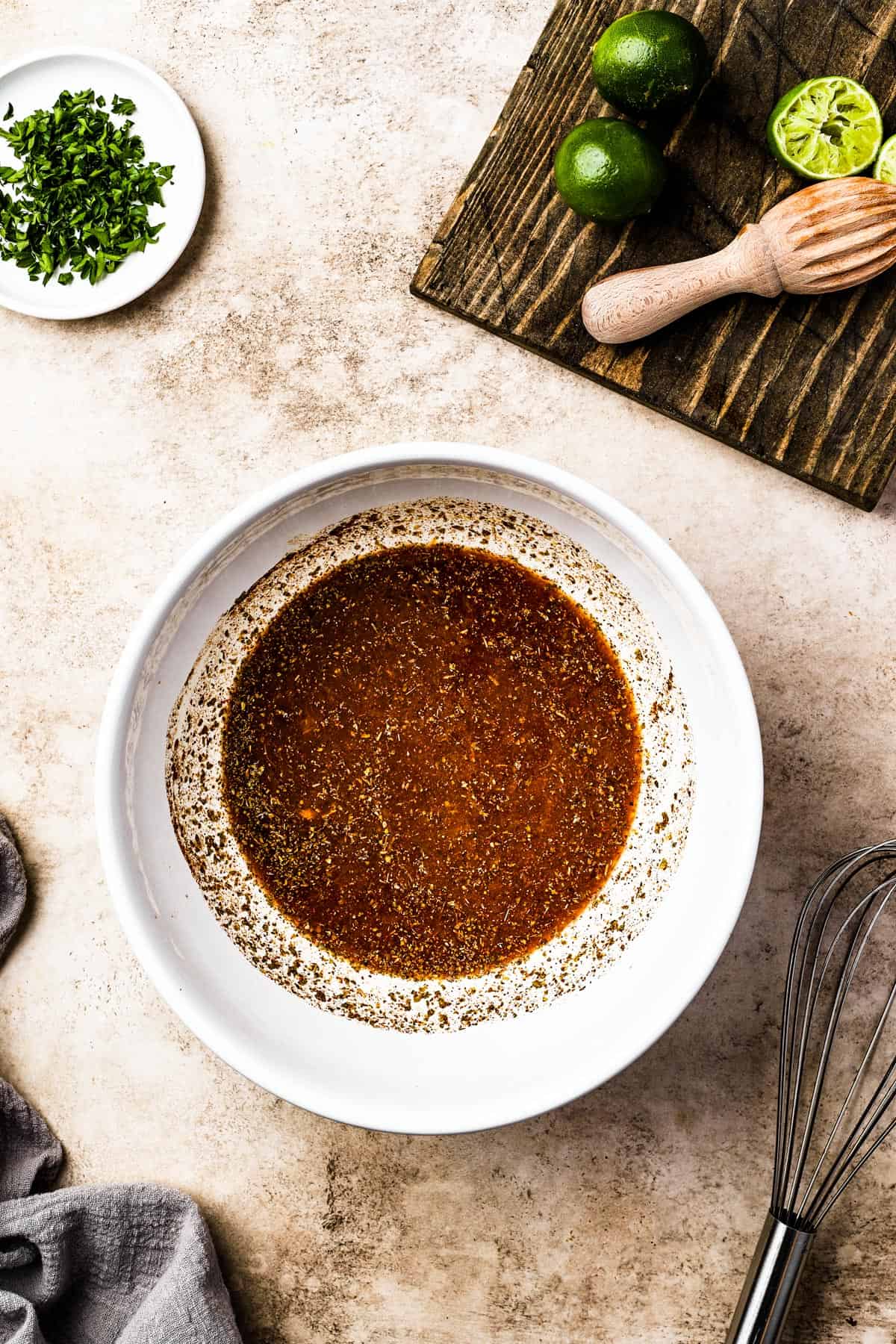 Tender and Crispy Slow Cooker Pork Carnitas 5 A citrus and spice mixture in a white bowl, ready for the slow cooker.