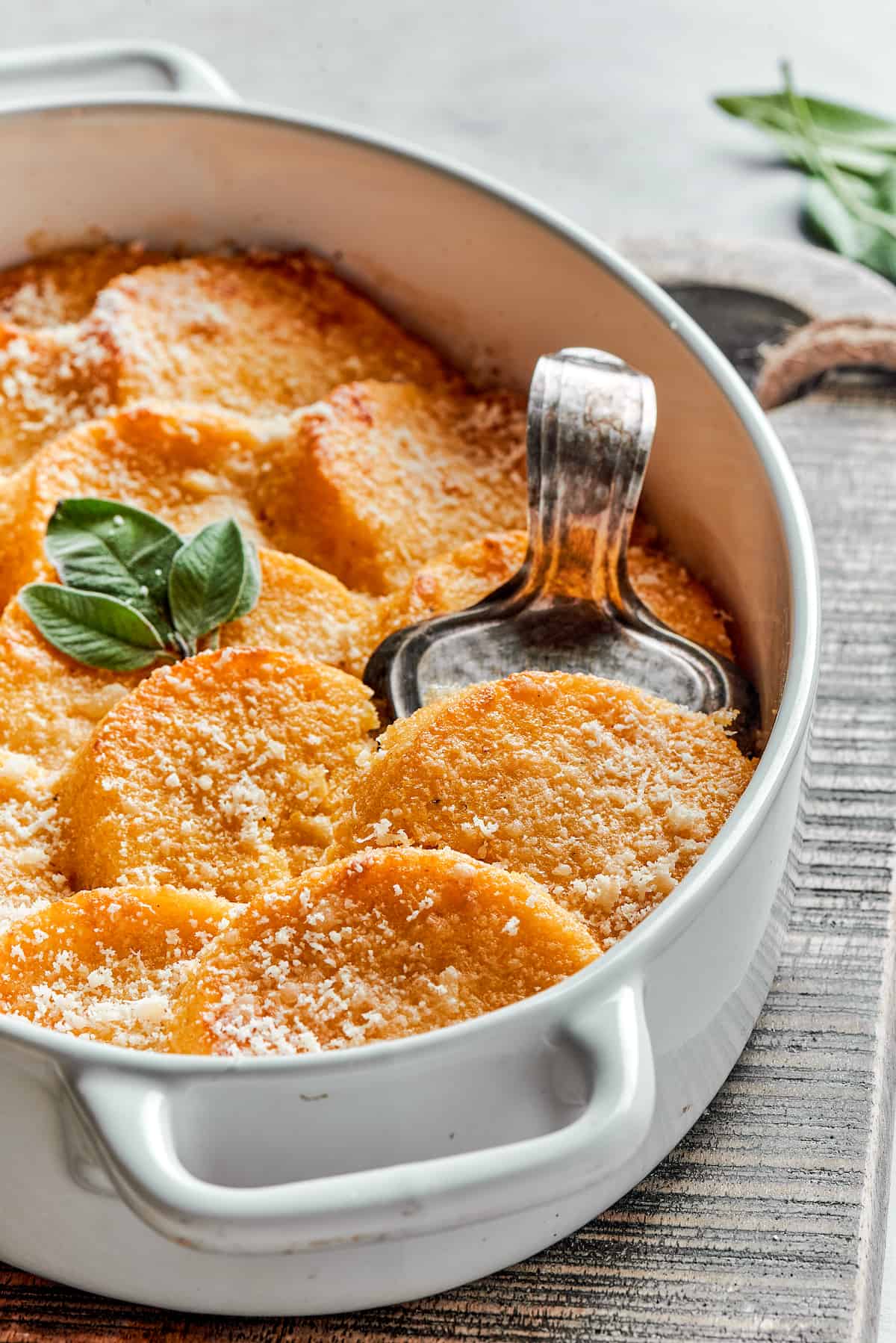 A serving dish of buttered gnocchi with parmesan.