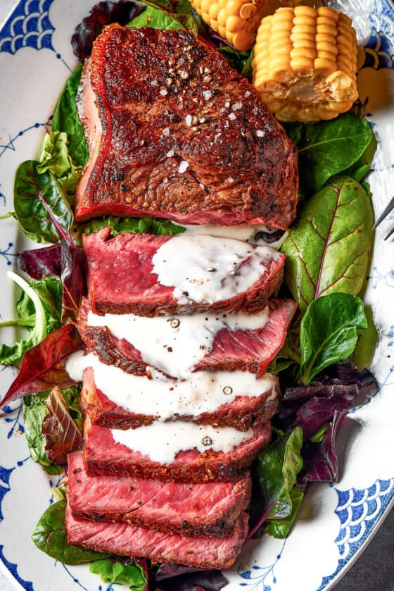 Sliced sirloin steak, with a drizzle of blue cheese sauce.