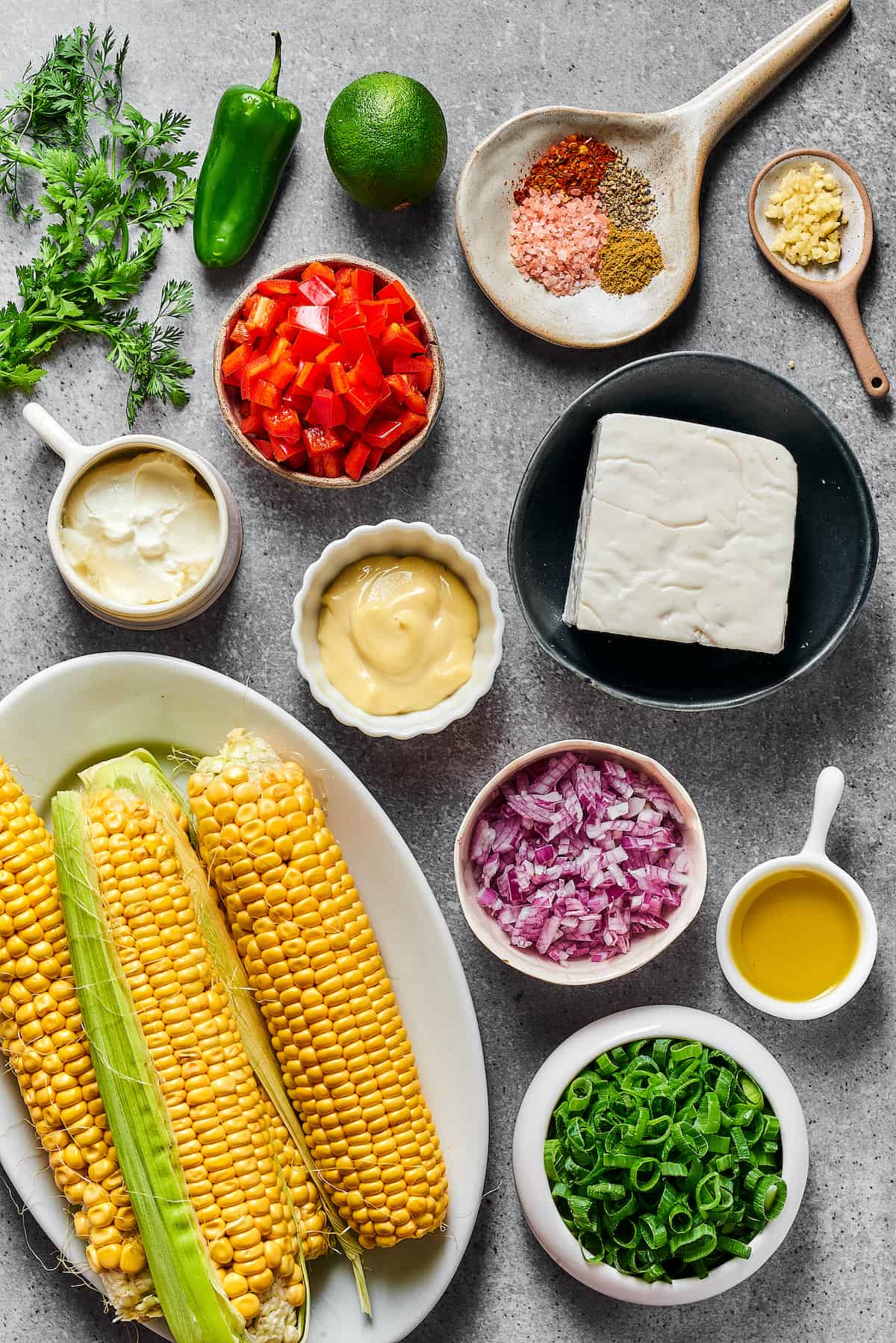 From top left: Cilantro, jalapeno, spices, minced garlic, sour cream, red bell pepper, mayonnaise, goat cheese, fresh corn, red onion, olive oil, chopped green onion.