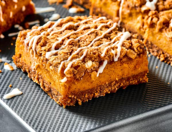 Pumpkin bars drizzled with cream cheese topping.