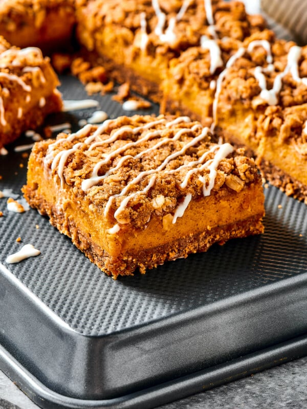 Pumpkin bars drizzled with cream cheese topping.