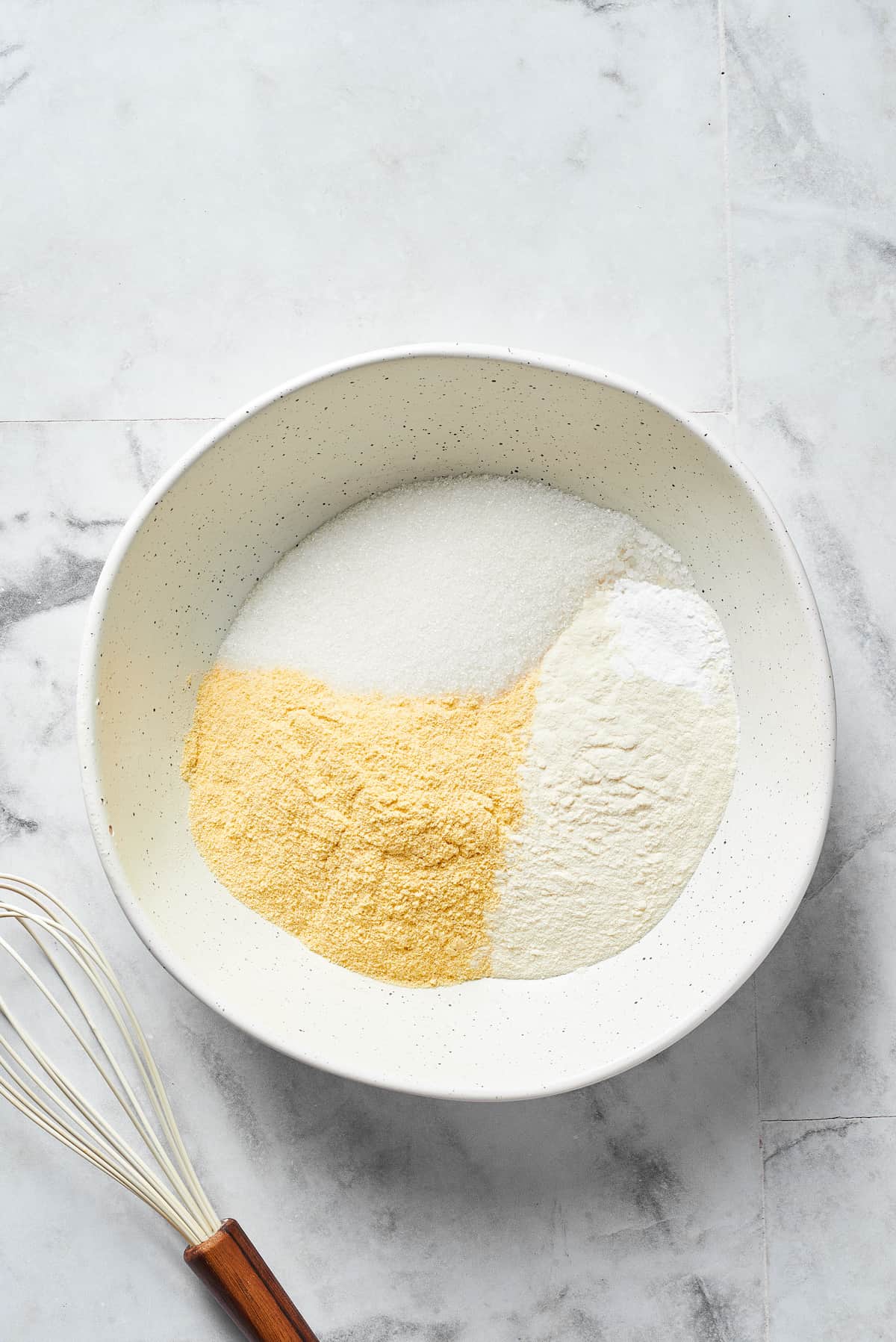 Dry cornbread ingredients in a bowl.