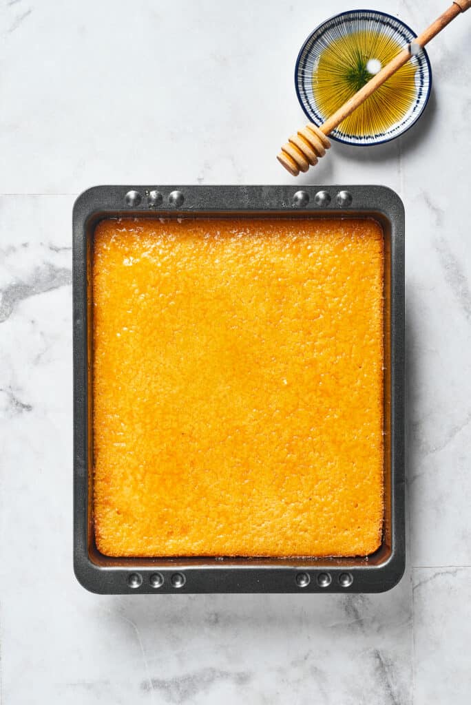 A loaf of cornbread in a baking dish.