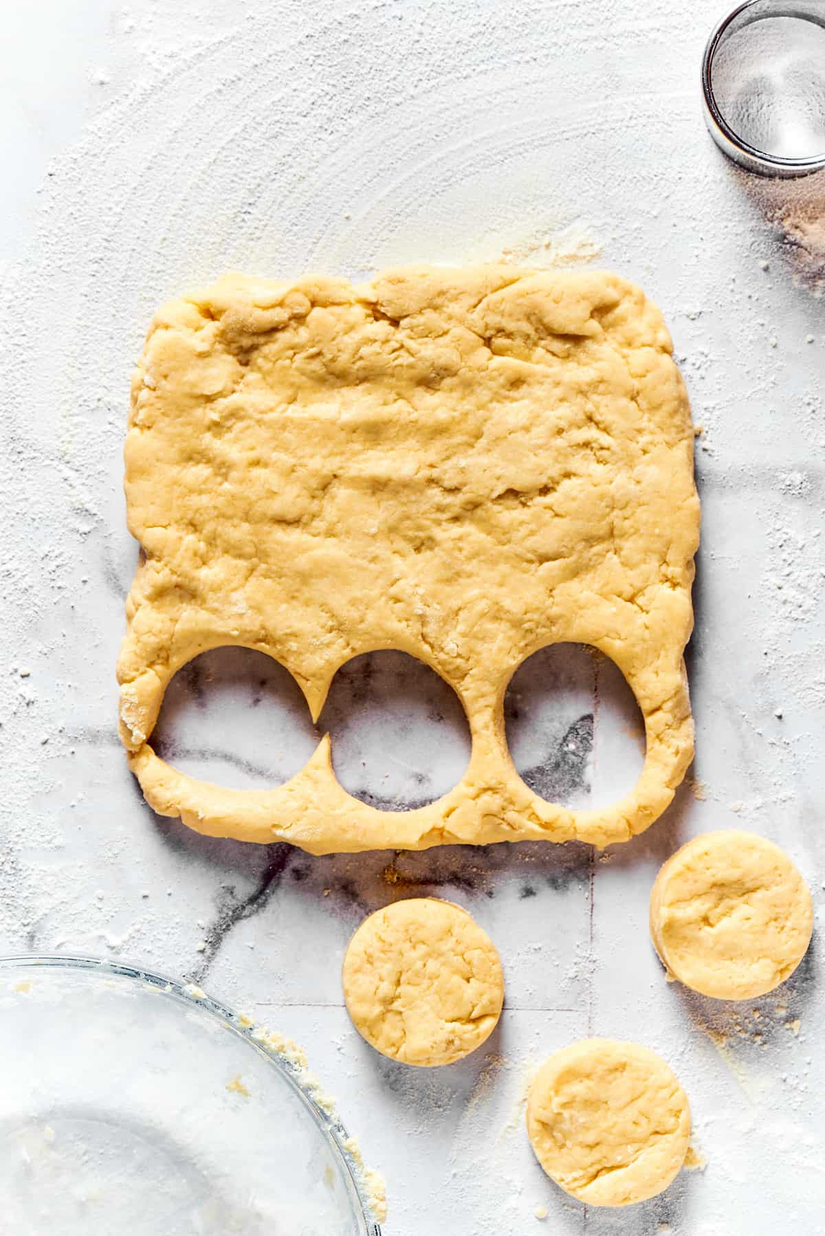 Cutting biscuits out of dough.