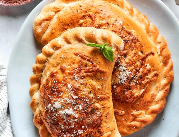 Two pizza pockets on a blue plate.
