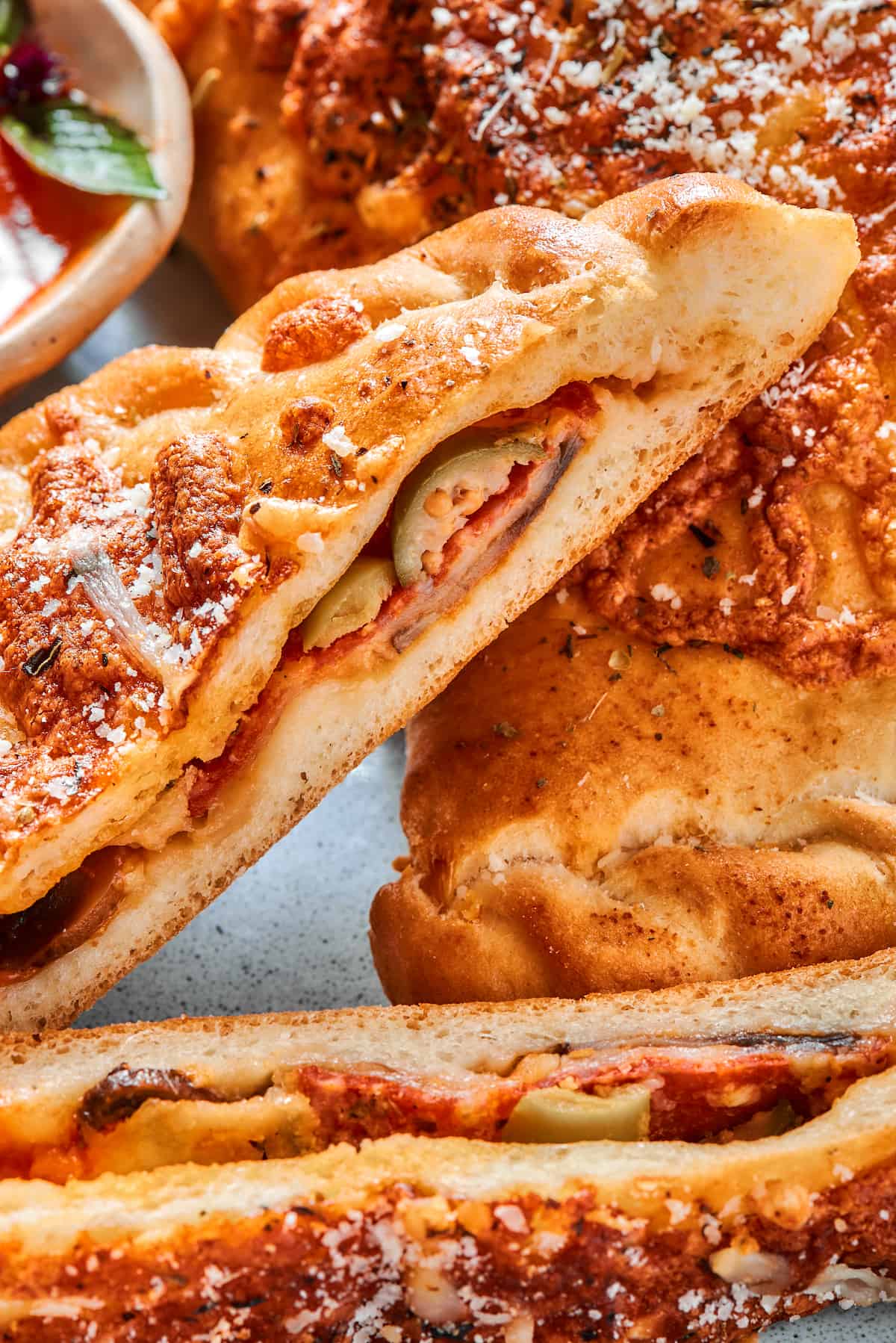 Close-up of the cut side of a halved pepperoni calzone.